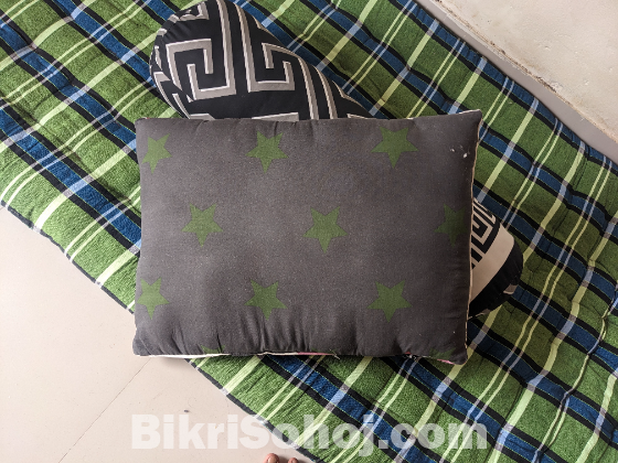 একটি সিঙ্গেল তোশক , কোল বালিশ এবং বালিশ